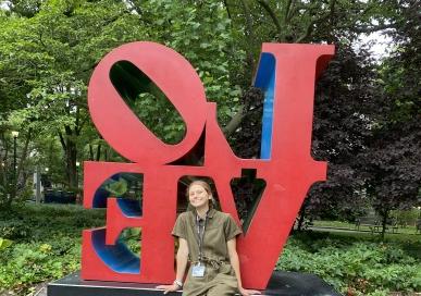 Hallie Kern sitting in front of the LOVE sign 